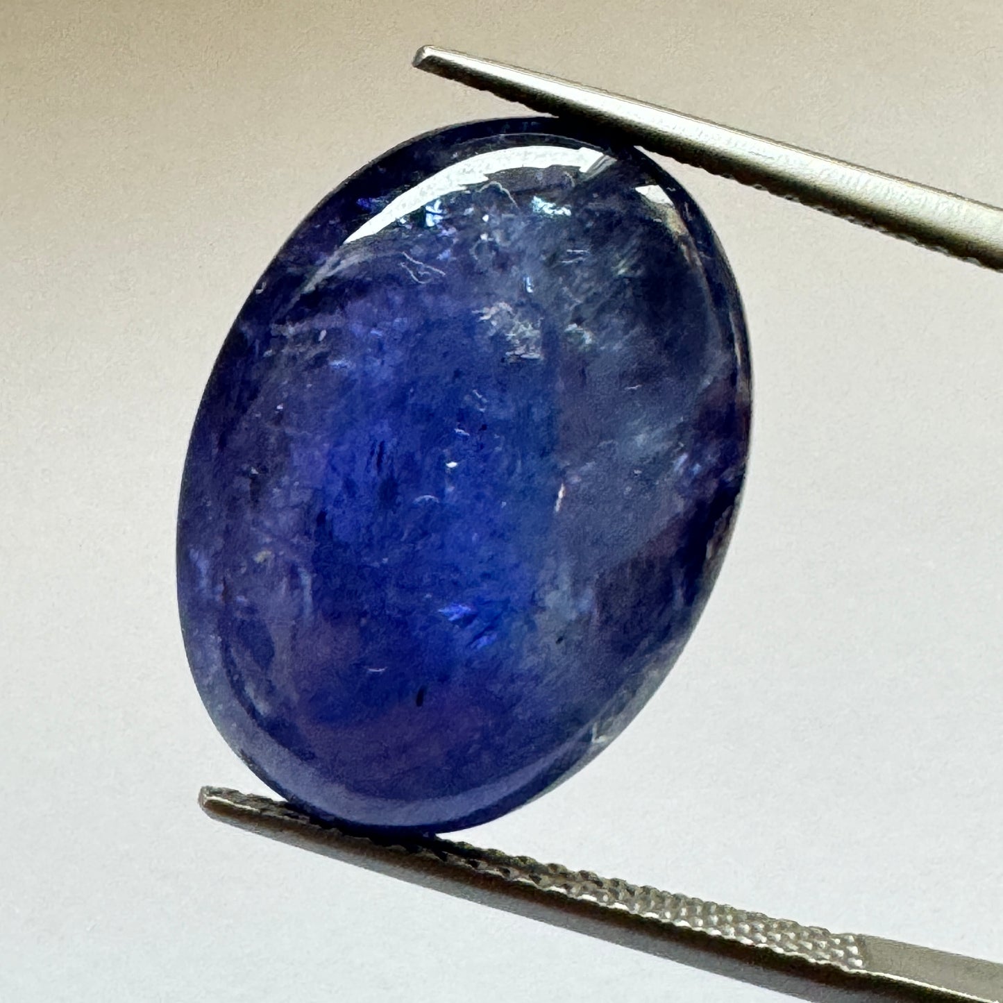 Ink blue Tanzanite oval Cabochon Faceted 19,3mm x 14,2mm 20,75cts