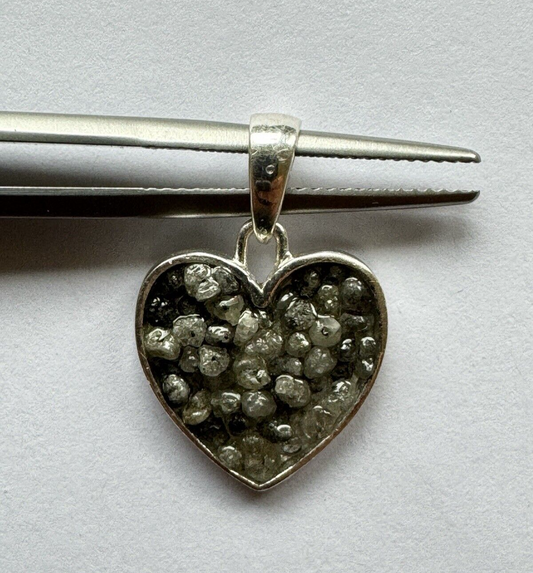 Heart and triangle pendant made of silver filled with diamonds