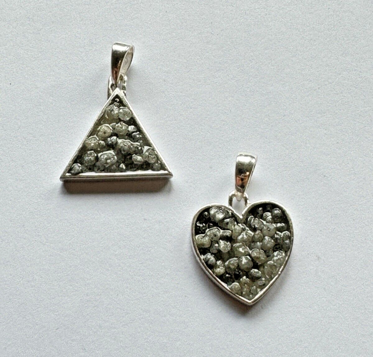 Heart and triangle pendant made of silver filled with diamonds