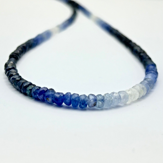 Delicate sapphire Beads faceted with gradient dark blue - light blue 59,09cts,