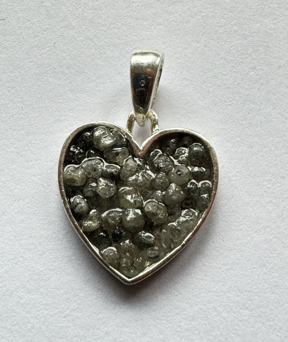 Heart and triangle pendant made of silver filled with diamonds