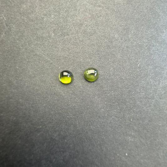 Peridot round cabochon pair, approx. 6.1mm and 5.7mm diameters, 1.85cts