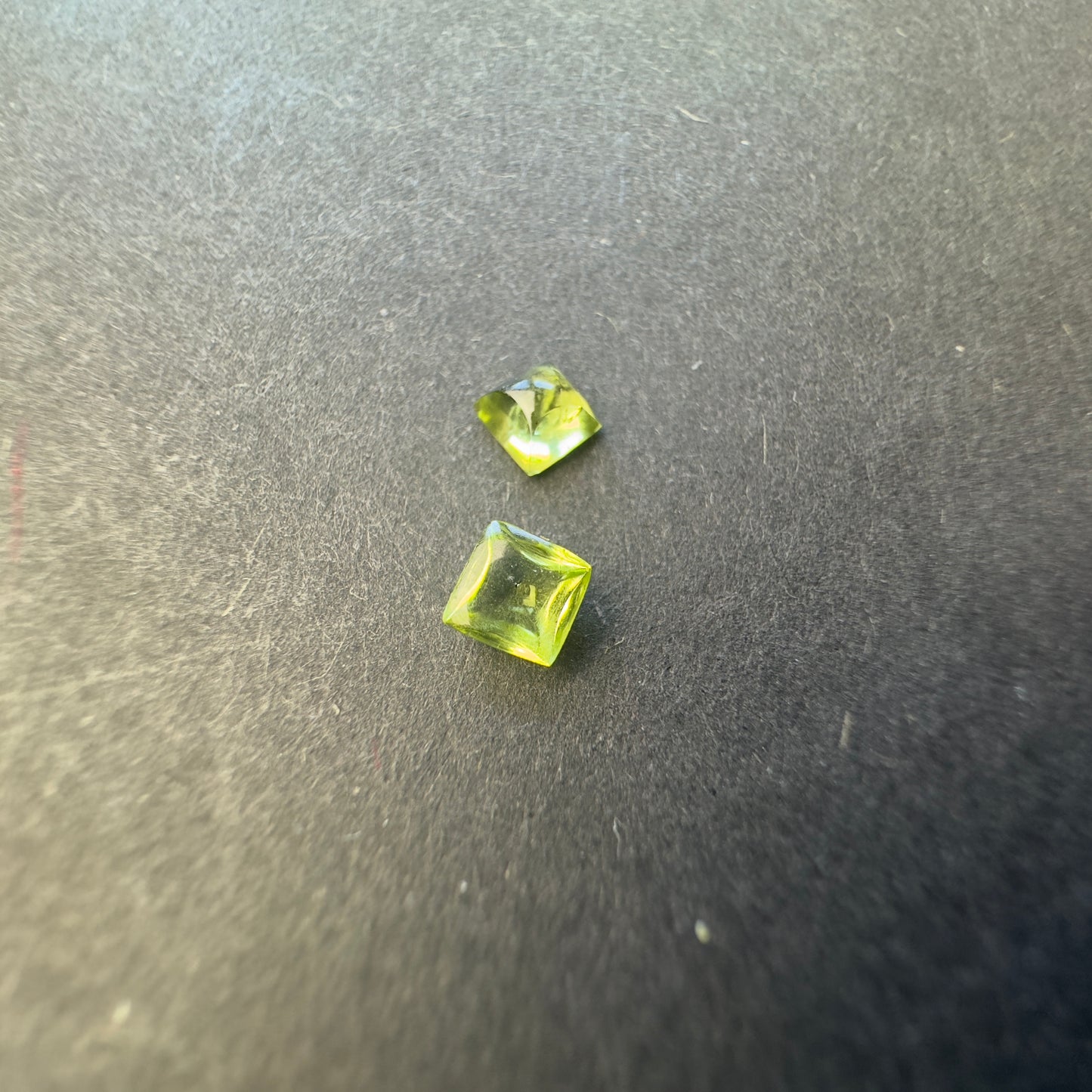Peridot pair, square cabochons, approx. 4.0x3.9mm & 3.8x3.7mm, 0.60cts