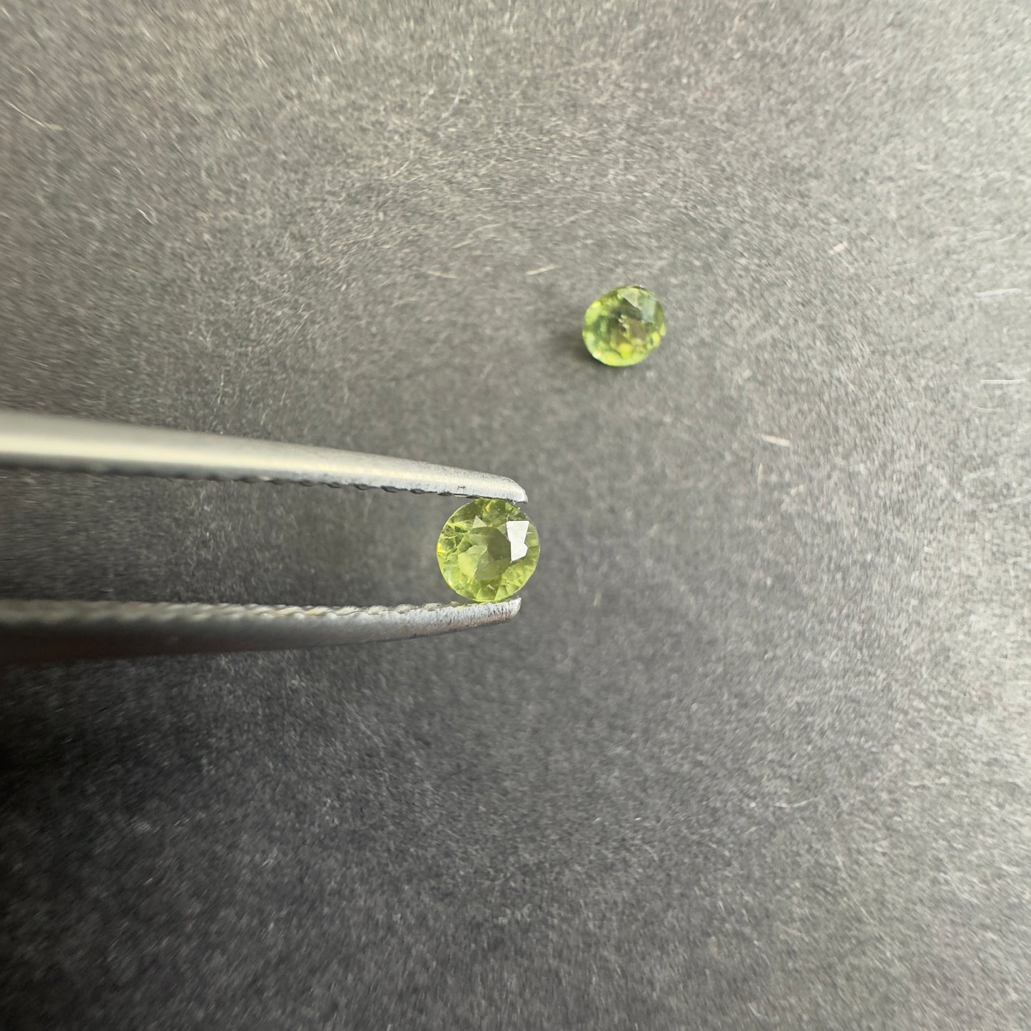 Peridot pair, round star cut, approx. 3.3mm & 3.1mm diameters, 0.30cts