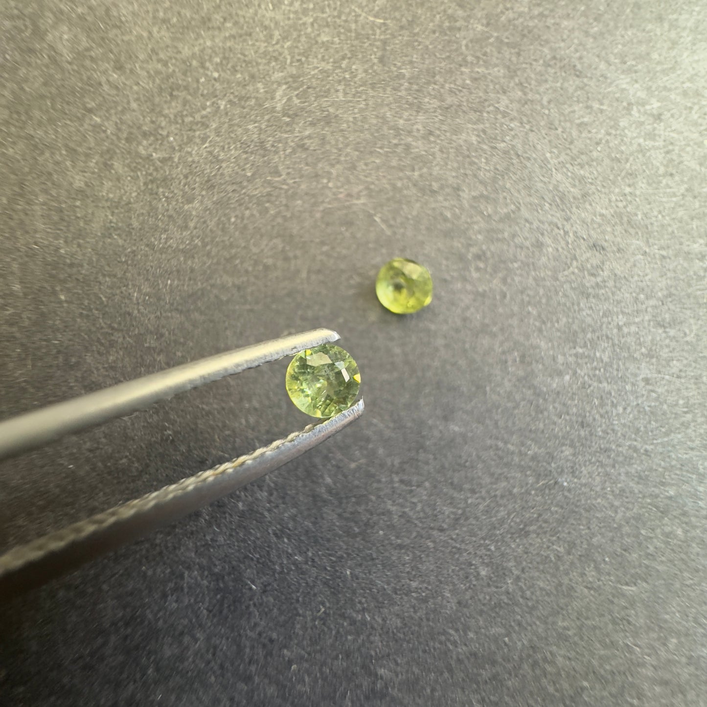 Peridot round pair, both approx. 3.3mm diameters, 0.31cts