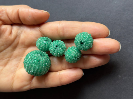 Deep green emerald pear-shaped stone with natural inclusions