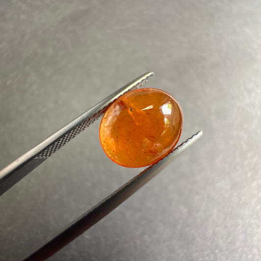 Glowing  Warmth with this Oval Mandarin Garnet Cabochon 12x10mm 7.4cts