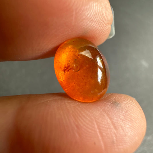 Glowing  Warmth with this Oval Mandarin Garnet Cabochon 12x10mm 7.4cts