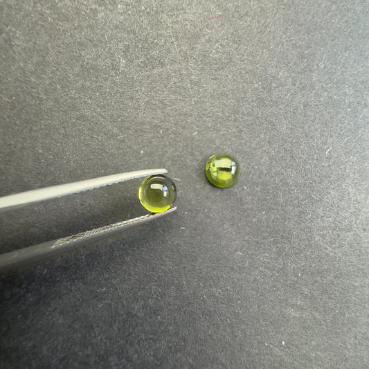 Peridot round cabochon pair, approx. 6.1mm and 5.7mm diameters, 1.85cts